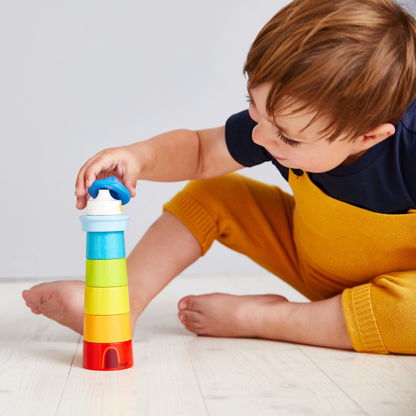 HABA Lighthouse Wooden Rainbow Stacker ‚Äì Colorful Learning Toy